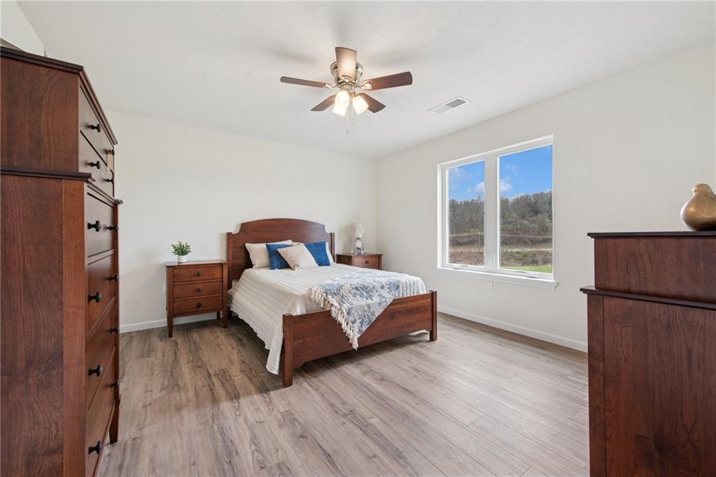 1632 Lois Road, Unit LOT 22 A Latrobe, PA 15650 - Photo 25 of 31 a bedroom with a bed and wooden floor