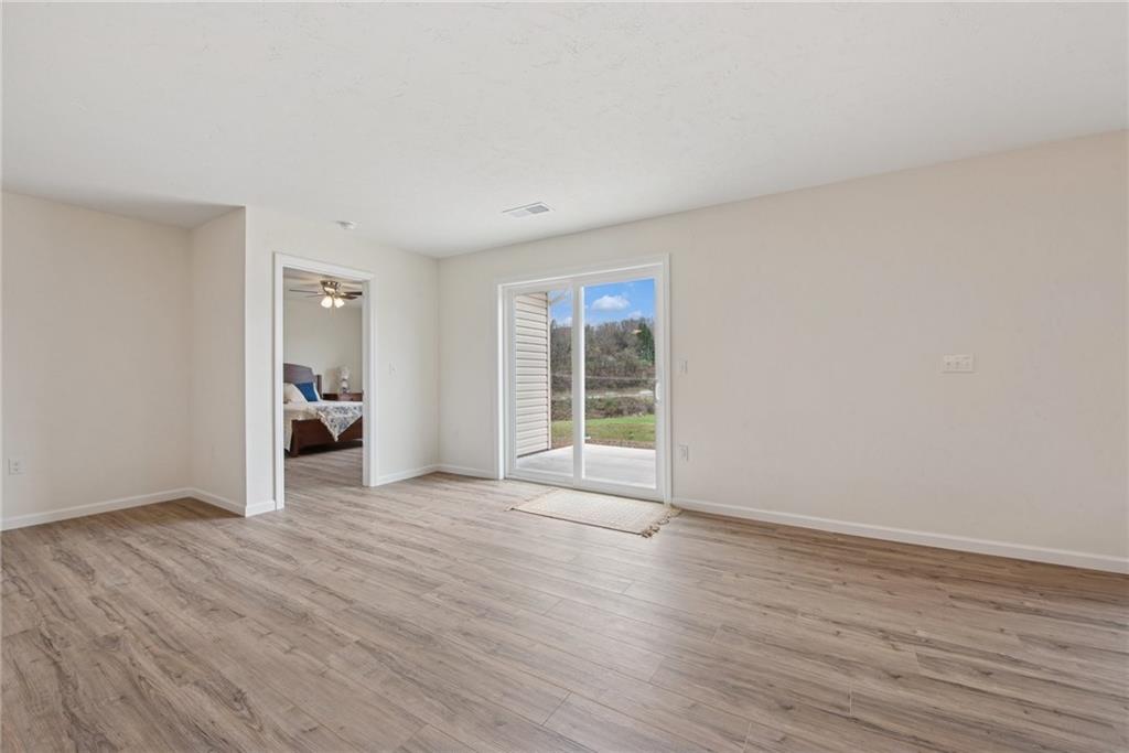 1632 Lois Road, Unit LOT 22 A Latrobe, PA 15650 - Photo 8 of 31 a view of an empty room with wooden floor and a window