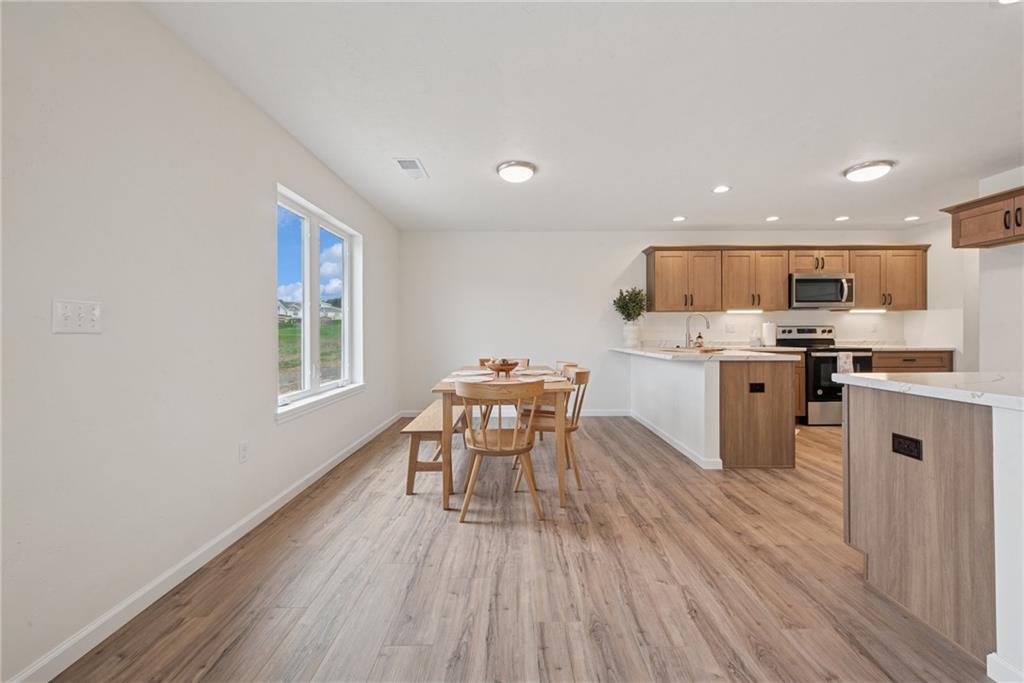 1632 Lois Road, Unit LOT 22 A Latrobe, PA 15650 - Photo 9 of 31 a kitchen with a table chairs a sink dishwasher window and cabinets