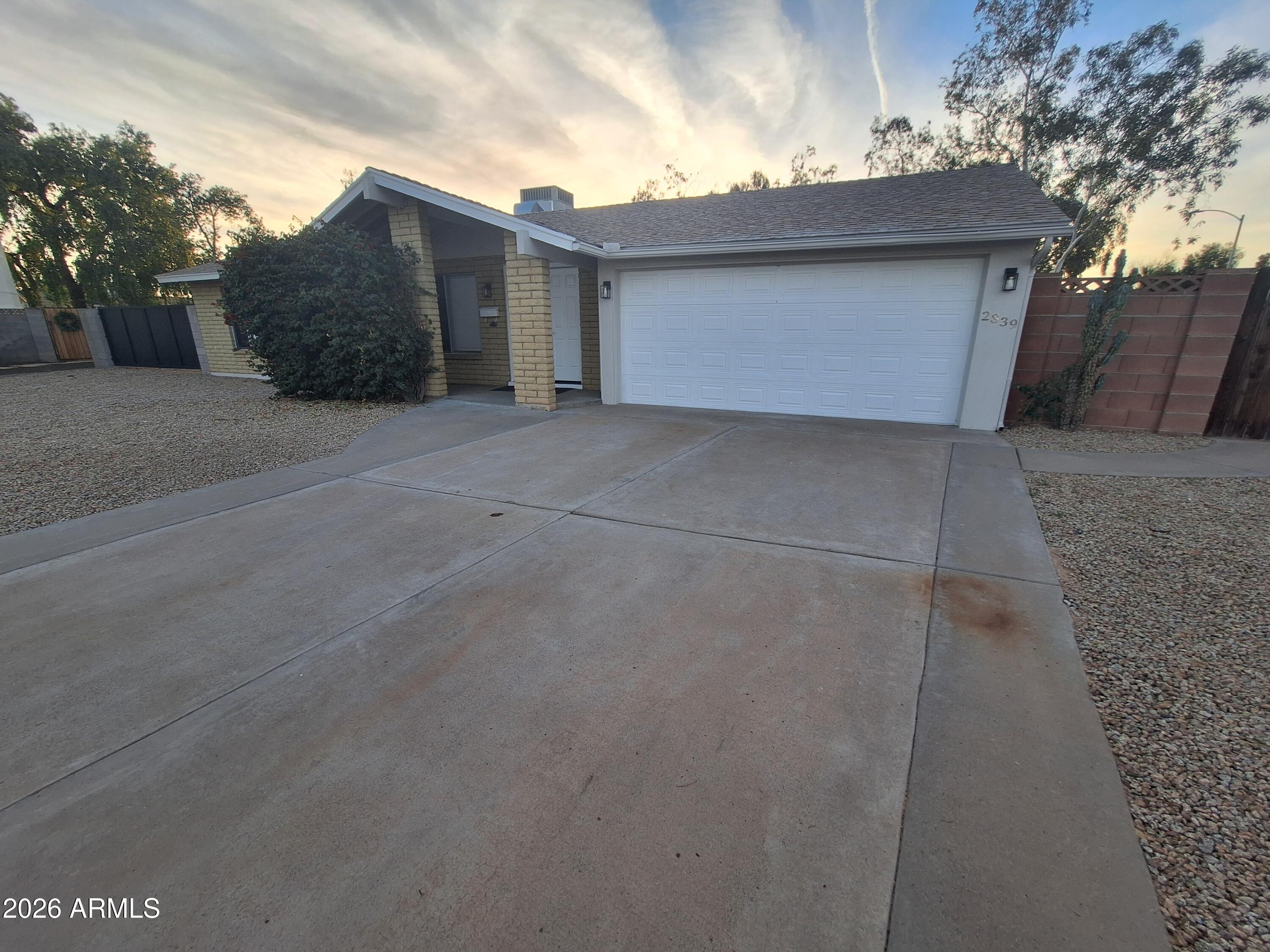 a view of a house with a yard and garage
