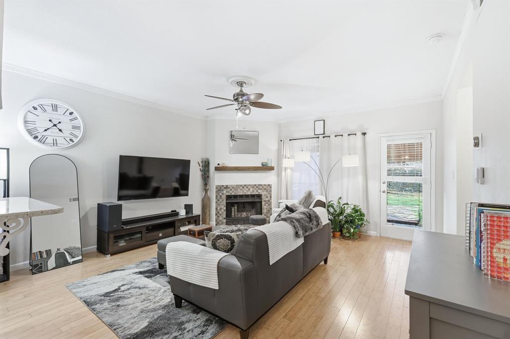 5619 Preston Oaks Road, Unit 305 Dallas, TX 75254 - Photo 13 of 35 a living room with furniture a fireplace and a flat screen tv