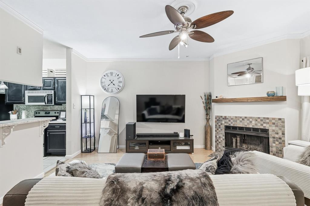 5619 Preston Oaks Road, Unit 305 Dallas, TX 75254 - Photo 17 of 35 a living room with furniture a fireplace and a flat screen tv