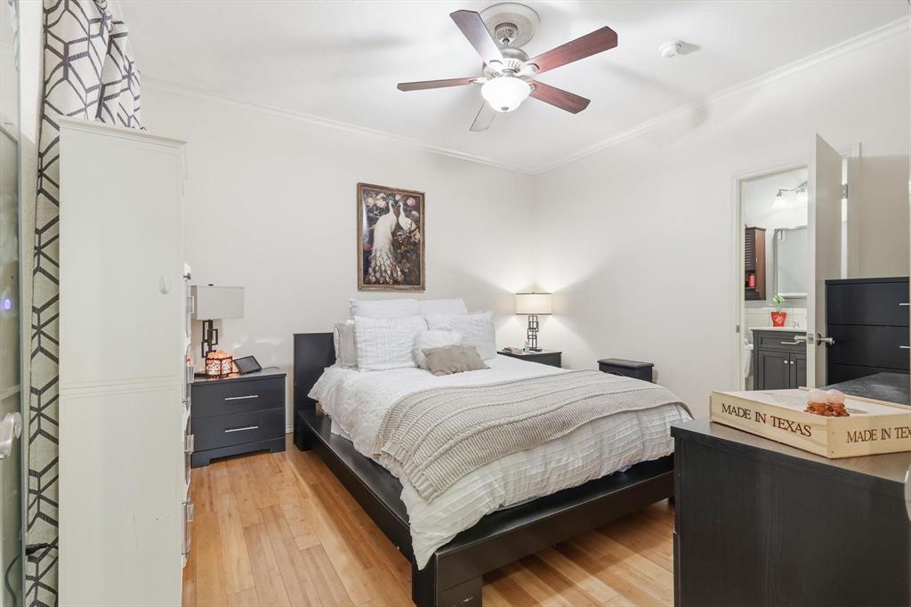 5619 Preston Oaks Road, Unit 305 Dallas, TX 75254 - Photo 18 of 35 a bedroom with a bed and a chandelier