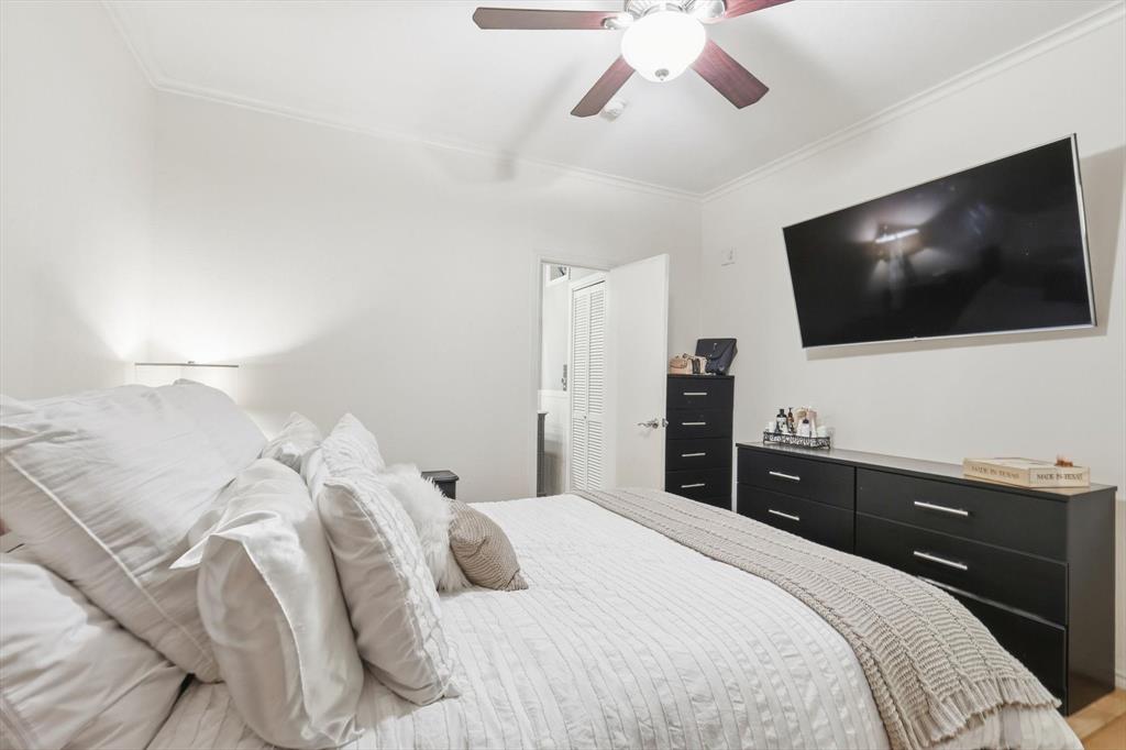 5619 Preston Oaks Road, Unit 305 Dallas, TX 75254 - Photo 20 of 35 a bedroom with a large bed and a flat screen tv