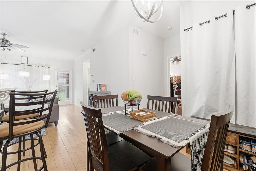 5619 Preston Oaks Road, Unit 305 Dallas, TX 75254 - Photo 5 of 35 a view of a dining room with furniture and wooden floor