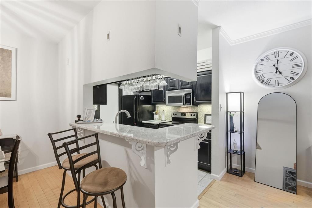 5619 Preston Oaks Road, Unit 305 Dallas, TX 75254 - Photo 8 of 35 a view of a dining room with furniture window and wooden floor