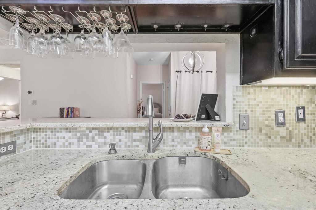 5619 Preston Oaks Road, Unit 305 Dallas, TX 75254 - Photo 10 of 35 Kit. has granite tops, serving bar, stainless stl appliances & open to the living rm.