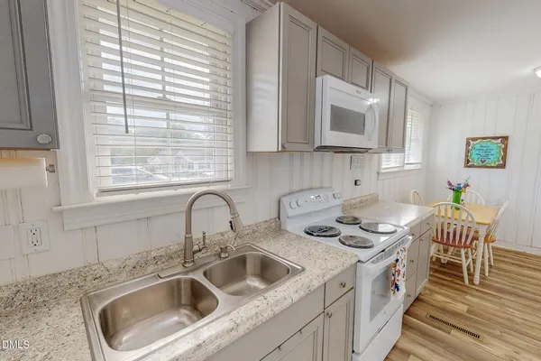 a kitchen with stainless steel appliances a sink a stove and a microwave
