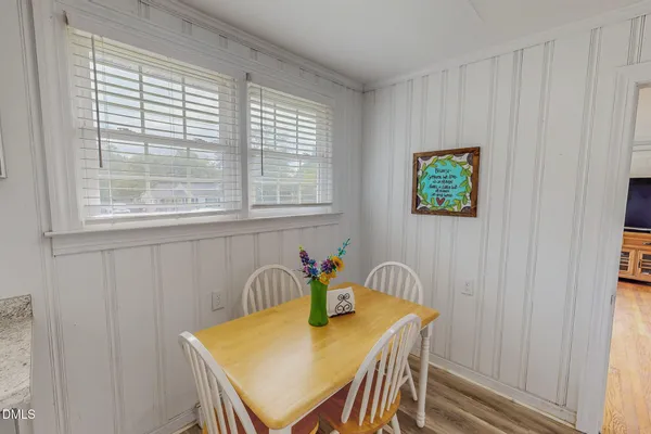 a view of a dining room with furniture and window