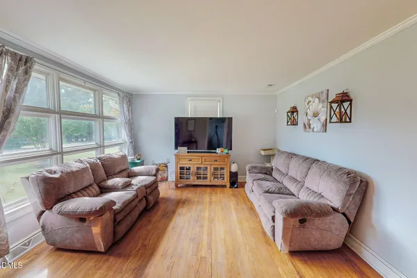 a living room with furniture and a flat screen tv
