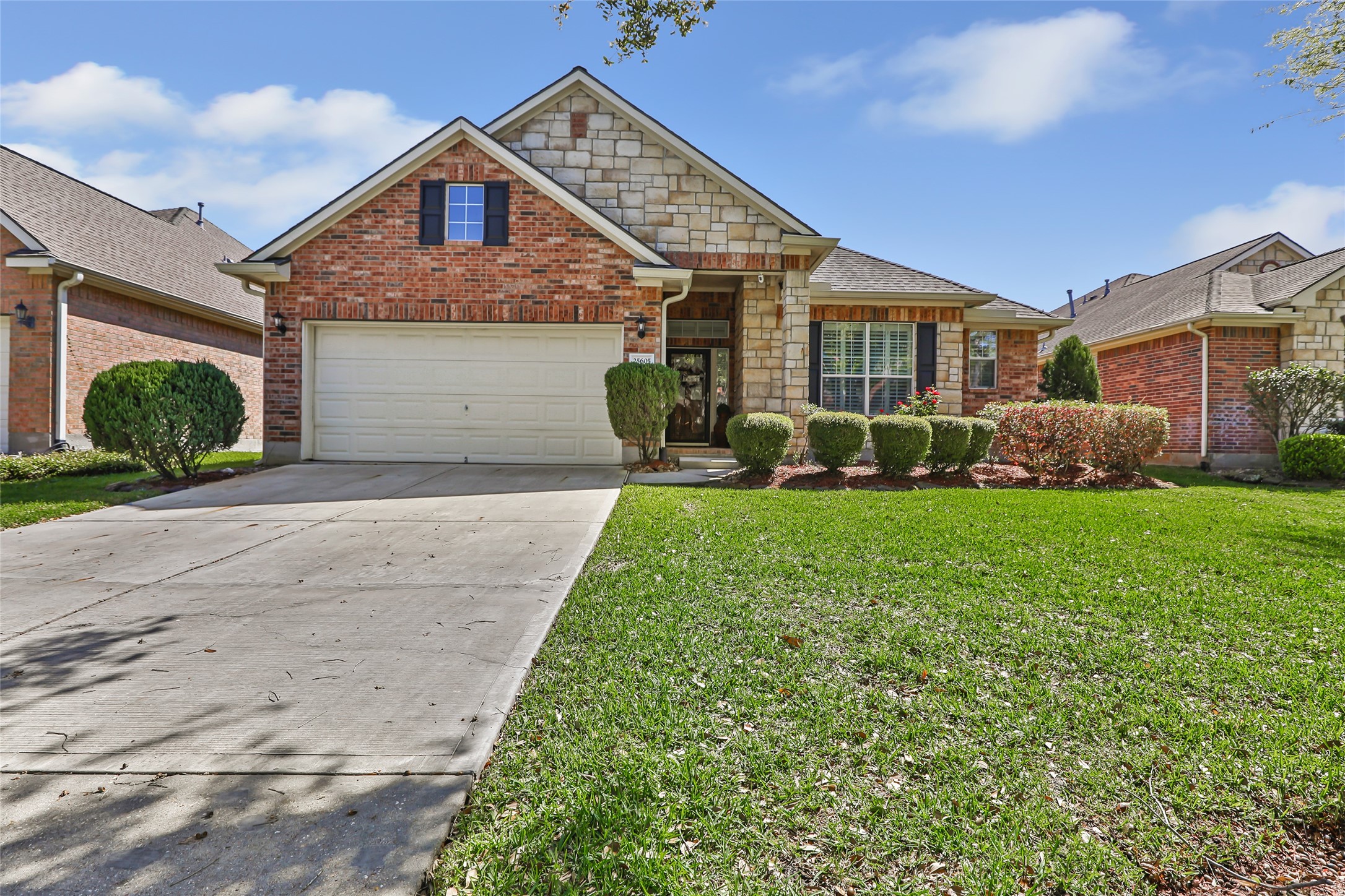 25605 Dartmaker Court Porter, TX 77365 - Photo 1 of 34 a front view of a house with a yard and garage