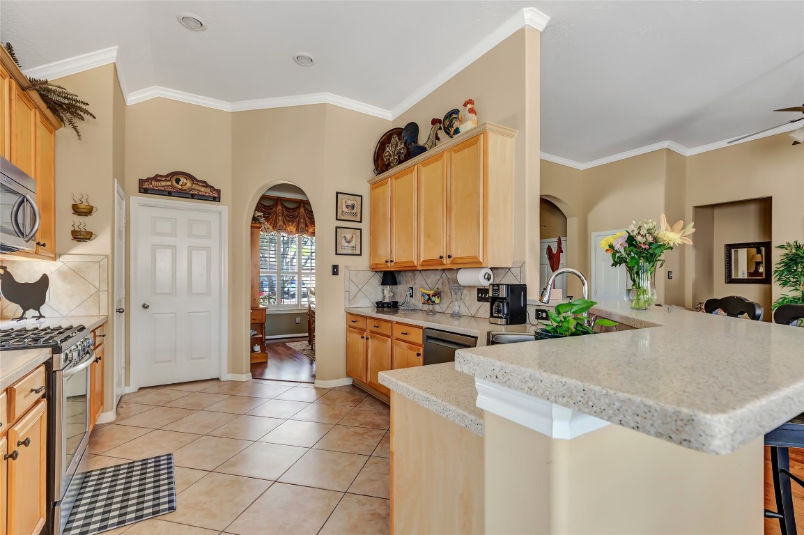 25605 Dartmaker Court Porter, TX 77365 - Photo 13 of 34 a kitchen with stainless steel appliances granite countertop a stove a sink and a refrigerator