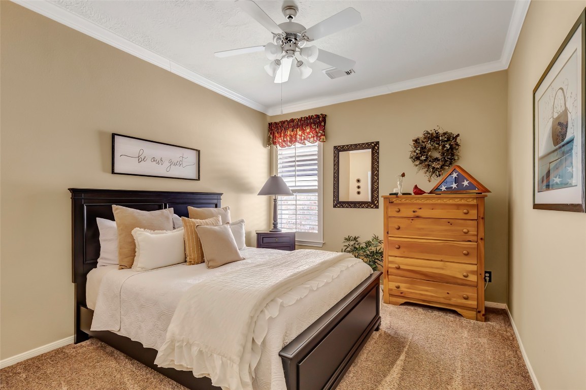 25605 Dartmaker Court Porter, TX 77365 - Photo 18 of 34 a bedroom with a bed and a chandelier