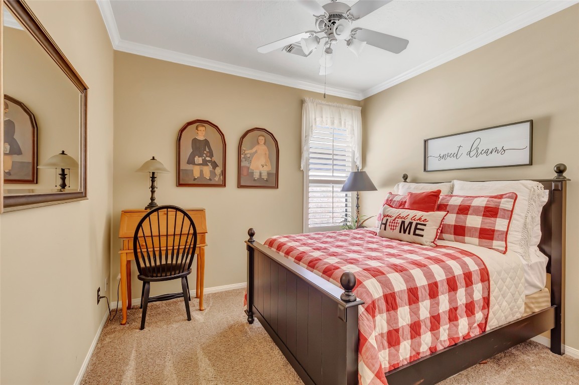 25605 Dartmaker Court Porter, TX 77365 - Photo 20 of 34 a bedroom with a bed and a chandelier