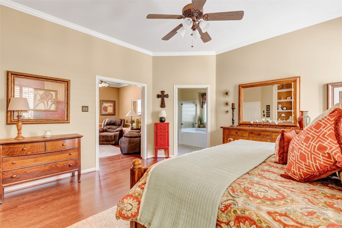 25605 Dartmaker Court Porter, TX 77365 - Photo 22 of 34 a bedroom with a large bed and a chandelier