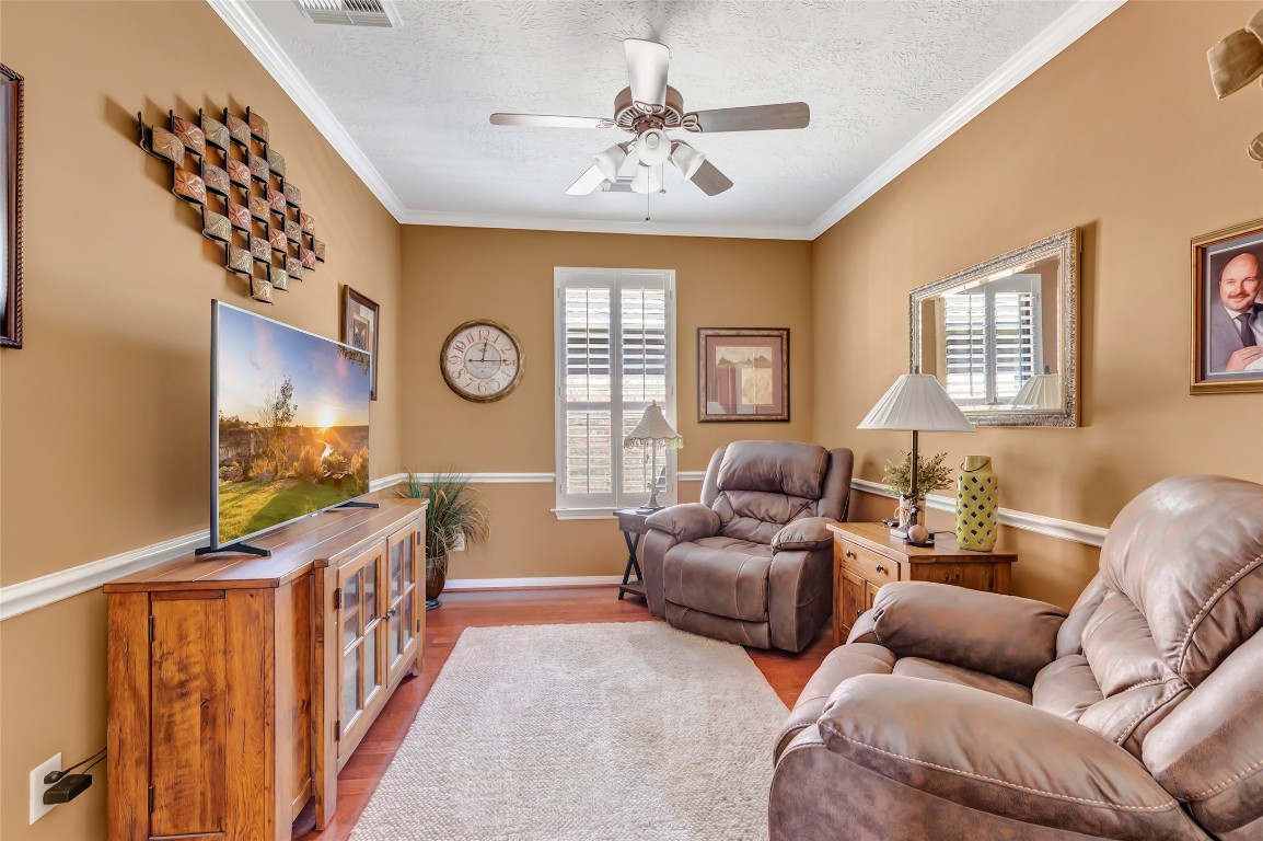 25605 Dartmaker Court Porter, TX 77365 - Photo 24 of 34 a living room with furniture a chandelier fan and a window