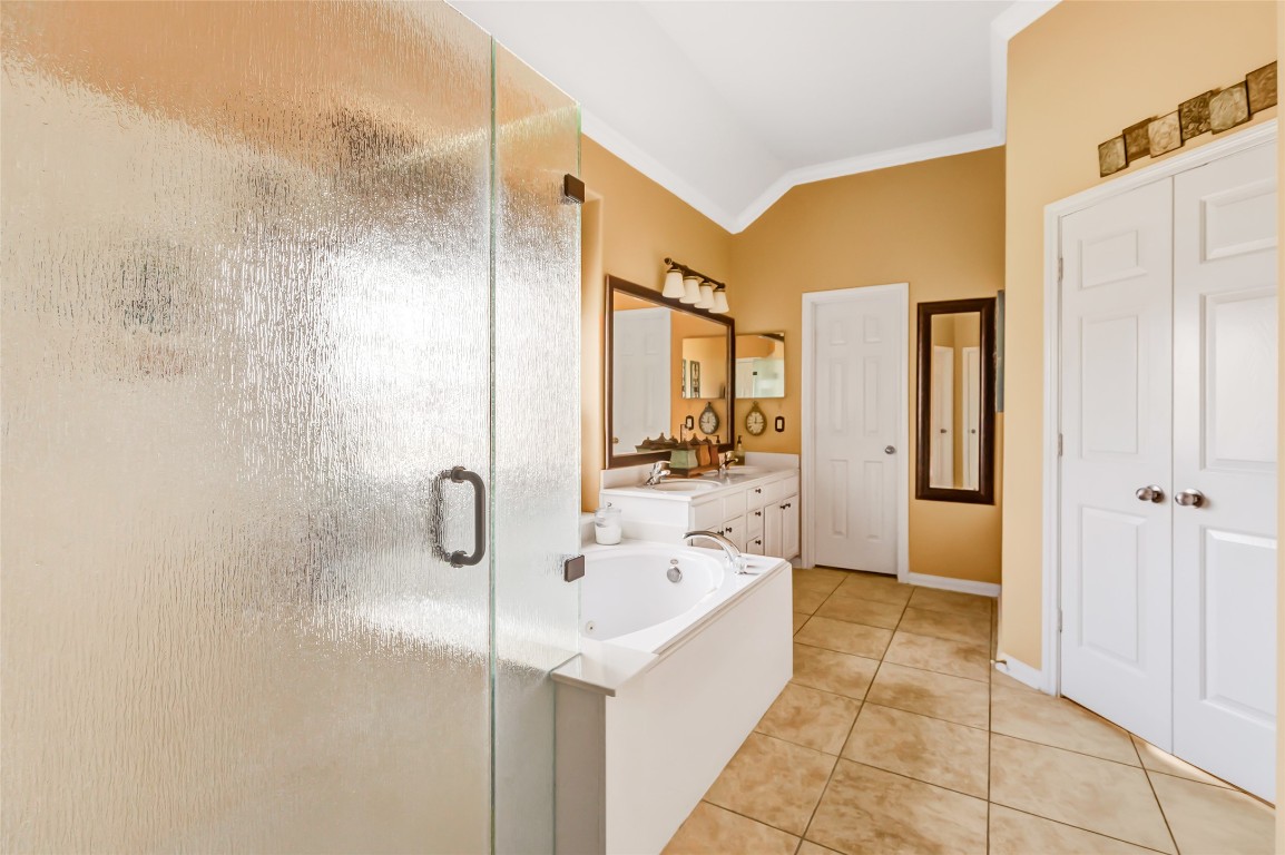 25605 Dartmaker Court Porter, TX 77365 - Photo 27 of 34 a bathroom with a tub sink and mirror