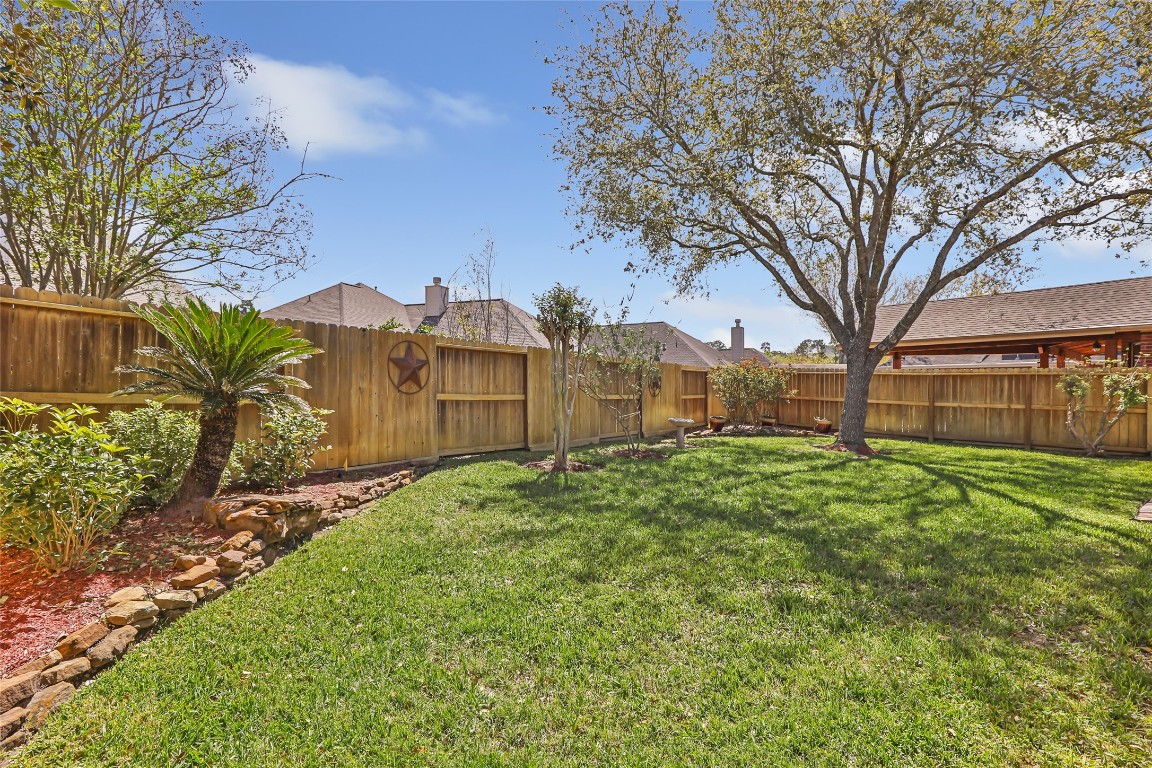 25605 Dartmaker Court Porter, TX 77365 - Photo 33 of 34 a view of a garden with a house