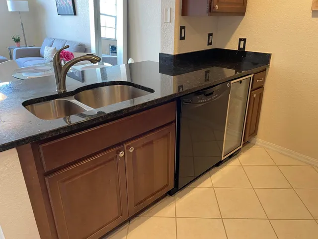 a kitchen with granite countertop a sink and a stove