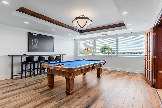 a living room with furniture a chandelier and a table
