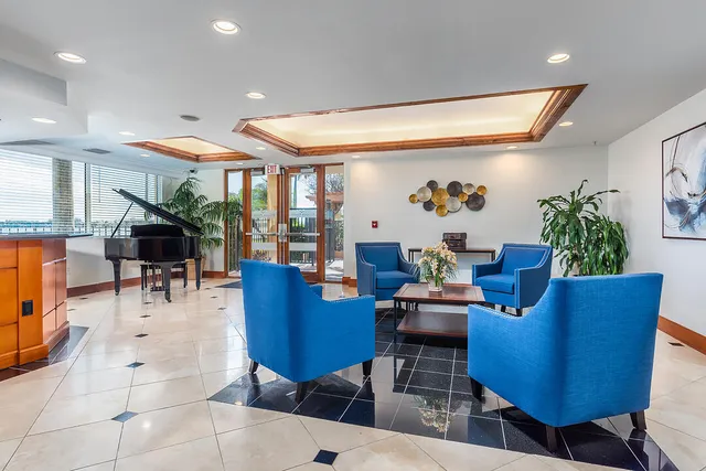 a living room with furniture a rug and a wall painting