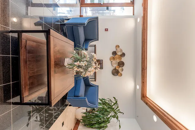 a reading room with furniture lamp and a potted plant