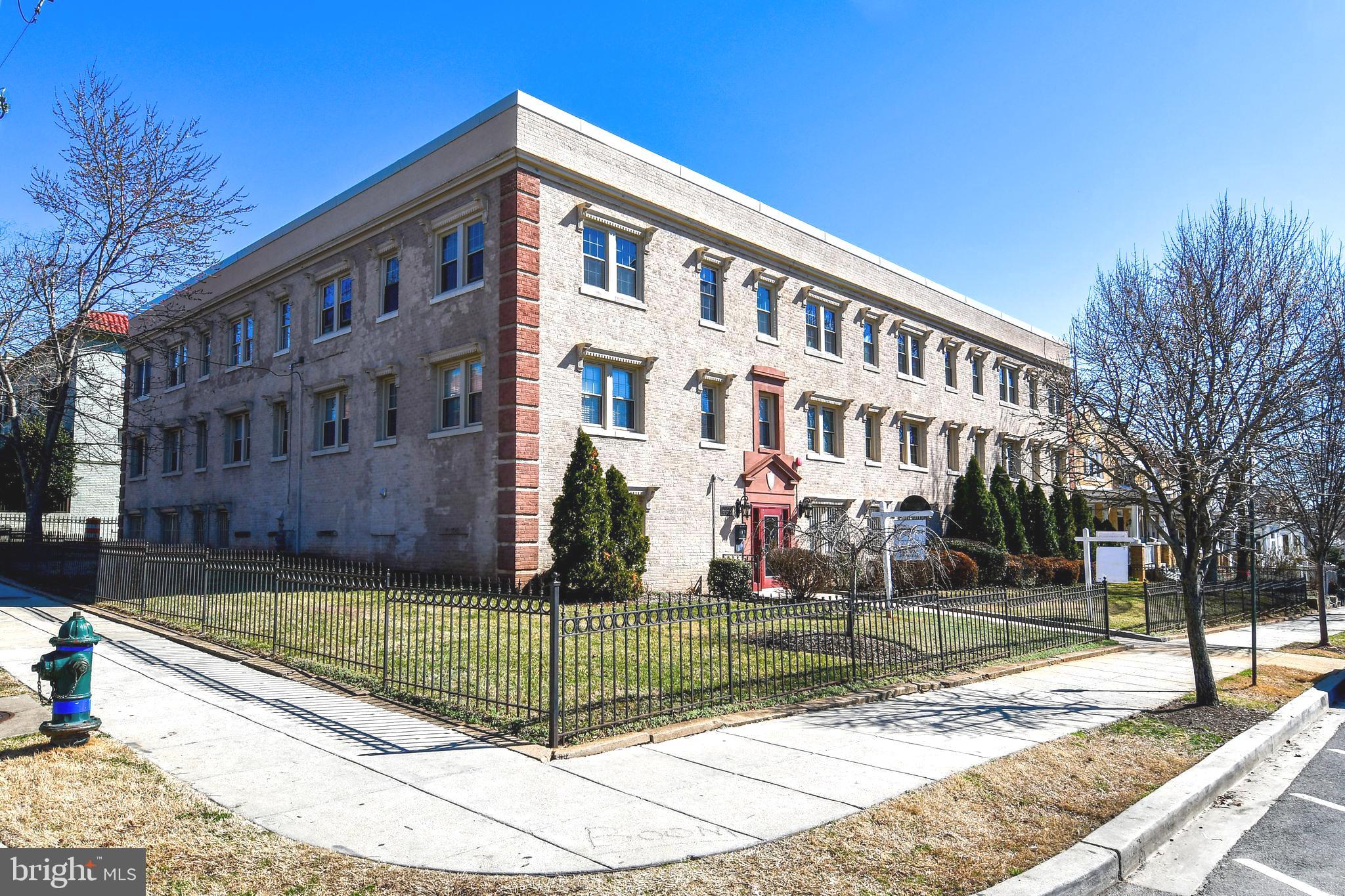 a view of a building with a yard