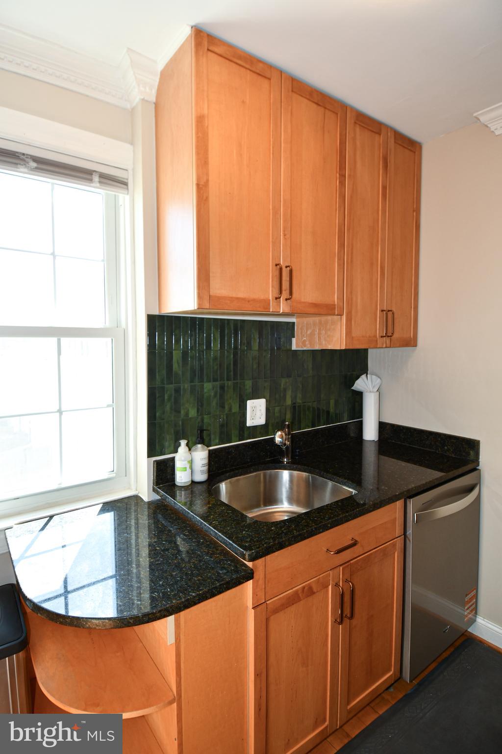 2625 3rd Street Northeast, Unit 301 Washington, DC 20002 - Photo 12 of 21 a kitchen with granite countertop a sink and a window