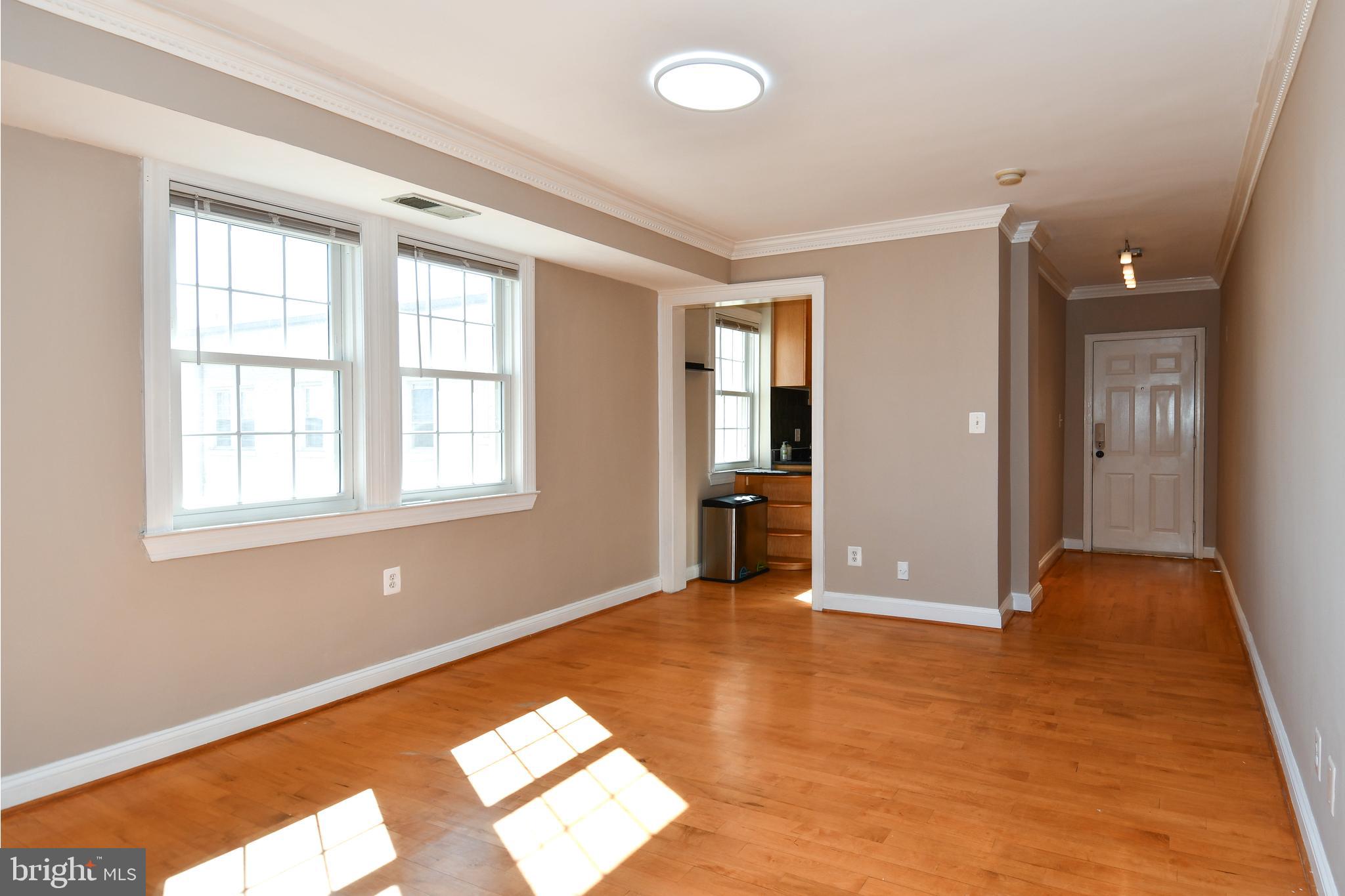 2625 3rd Street Northeast, Unit 301 Washington, DC 20002 - Photo 7 of 21 wooden floor in an empty room with a window