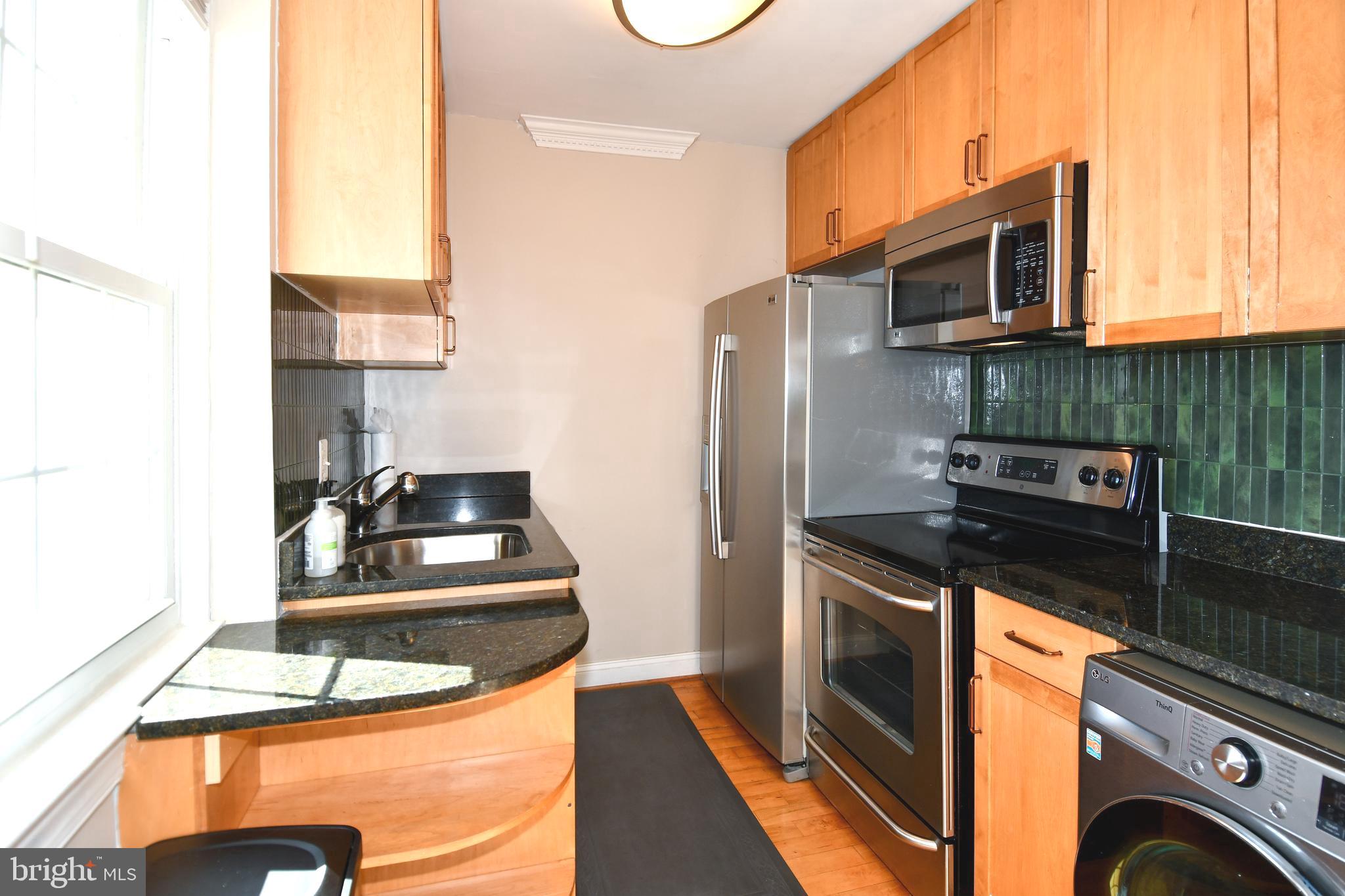2625 3rd Street Northeast, Unit 301 Washington, DC 20002 - Photo 9 of 21 a kitchen with stainless steel appliances granite countertop a stove microwave and sink