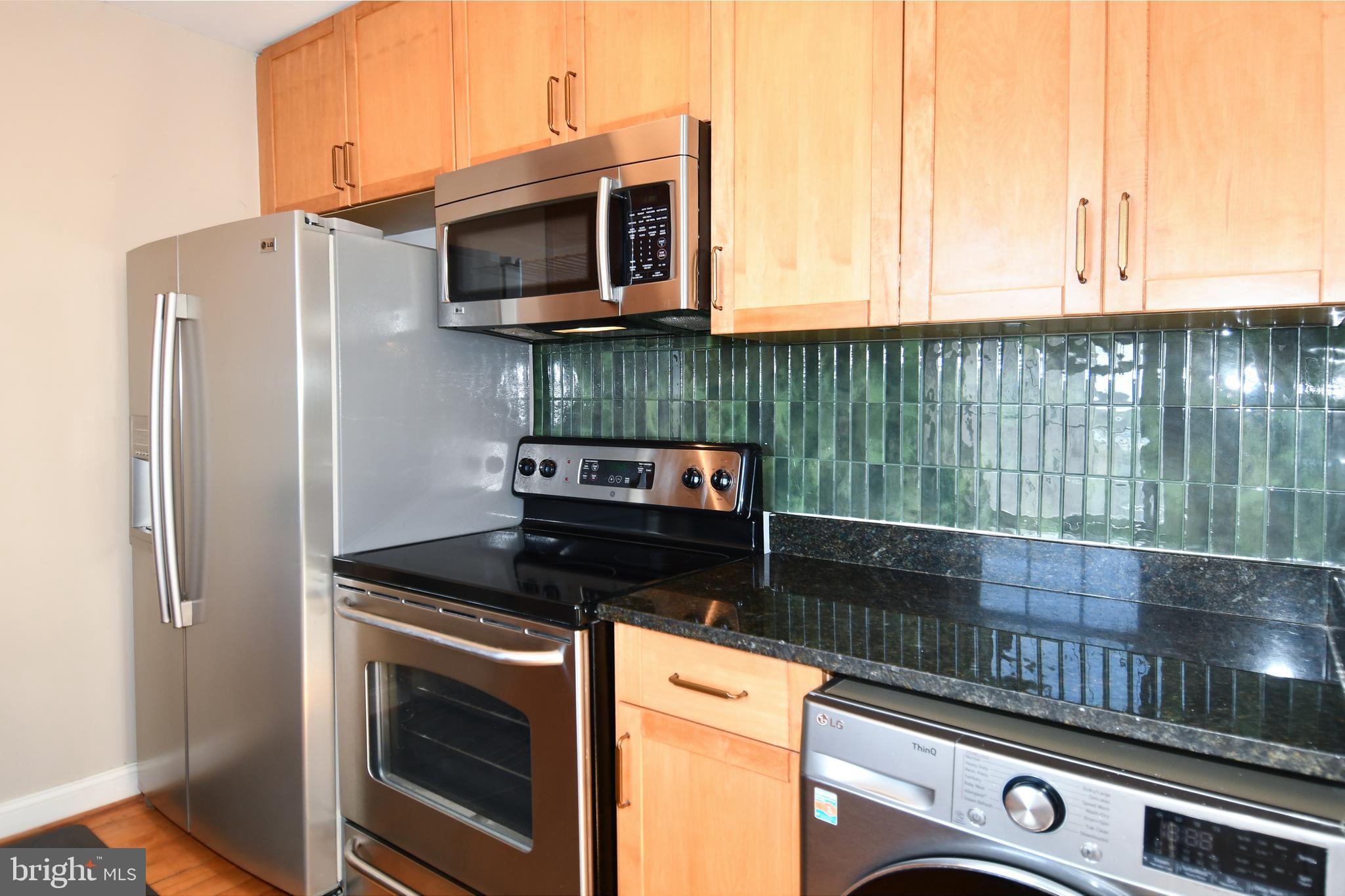 2625 3rd Street Northeast, Unit 301 Washington, DC 20002 - Photo 10 of 21 a kitchen with a stove and a microwave