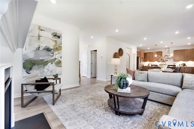 a living room with furniture a rug and a chandelier