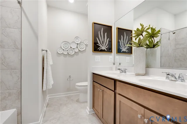 a bathroom with a toilet sink vanity and mirror