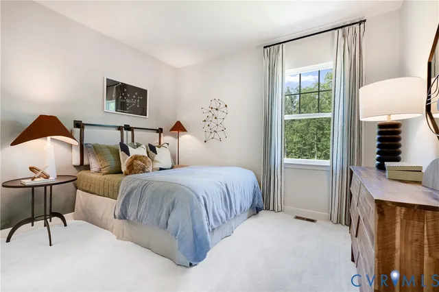 a bedroom with two beds and painting on the wall