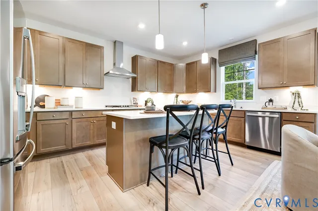 a kitchen with a table chairs microwave and cabinets
