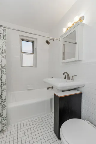 a bathroom with a sink a toilet and a bathtub