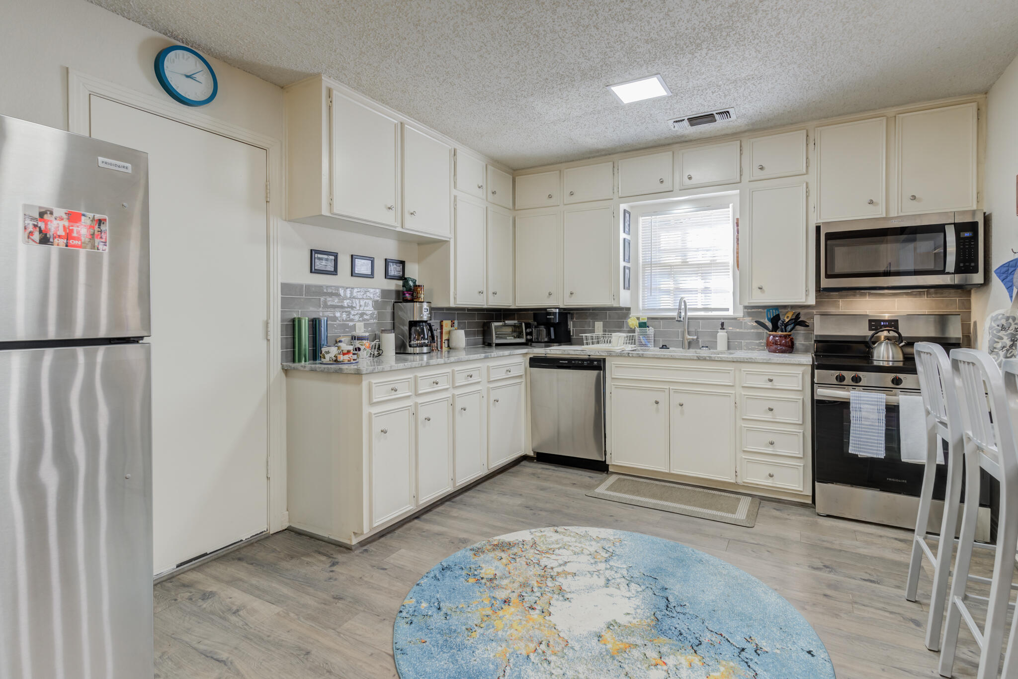 2822 23rd Street Lubbock, TX 79410 - Photo 12 of 39 a kitchen with white cabinets stainless steel appliances and sink