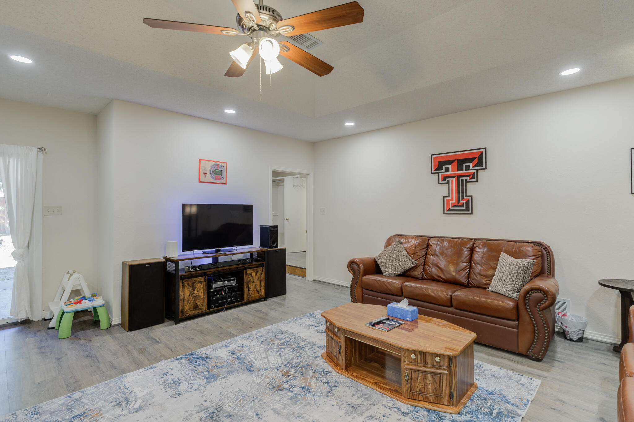 2822 23rd Street Lubbock, TX 79410 - Photo 17 of 39 a living room with furniture and a flat screen tv