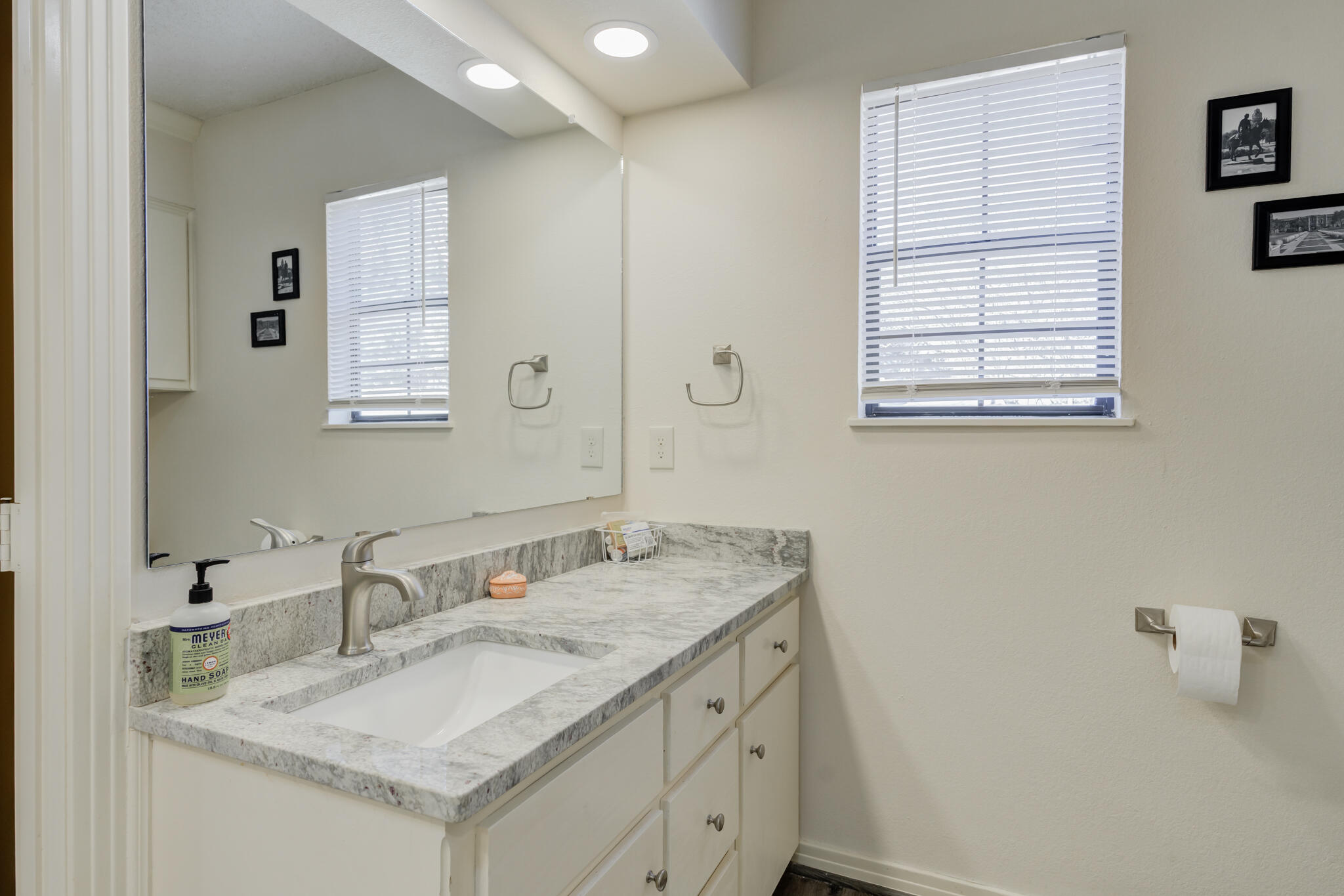 2822 23rd Street Lubbock, TX 79410 - Photo 27 of 39 a bathroom with a granite countertop sink and a mirror