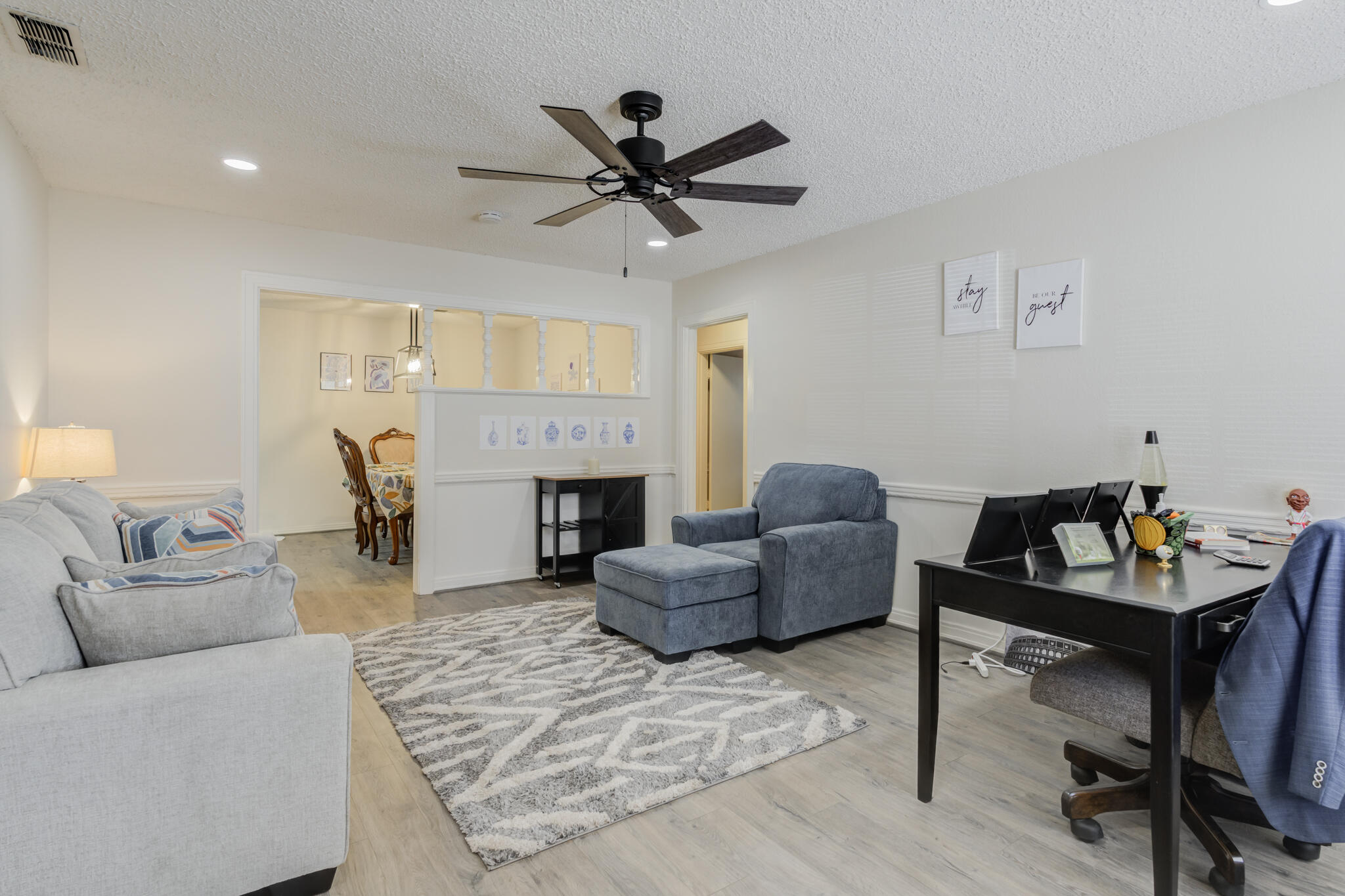 2822 23rd Street Lubbock, TX 79410 - Photo 3 of 39 a living room with furniture a fireplace and a flat screen tv