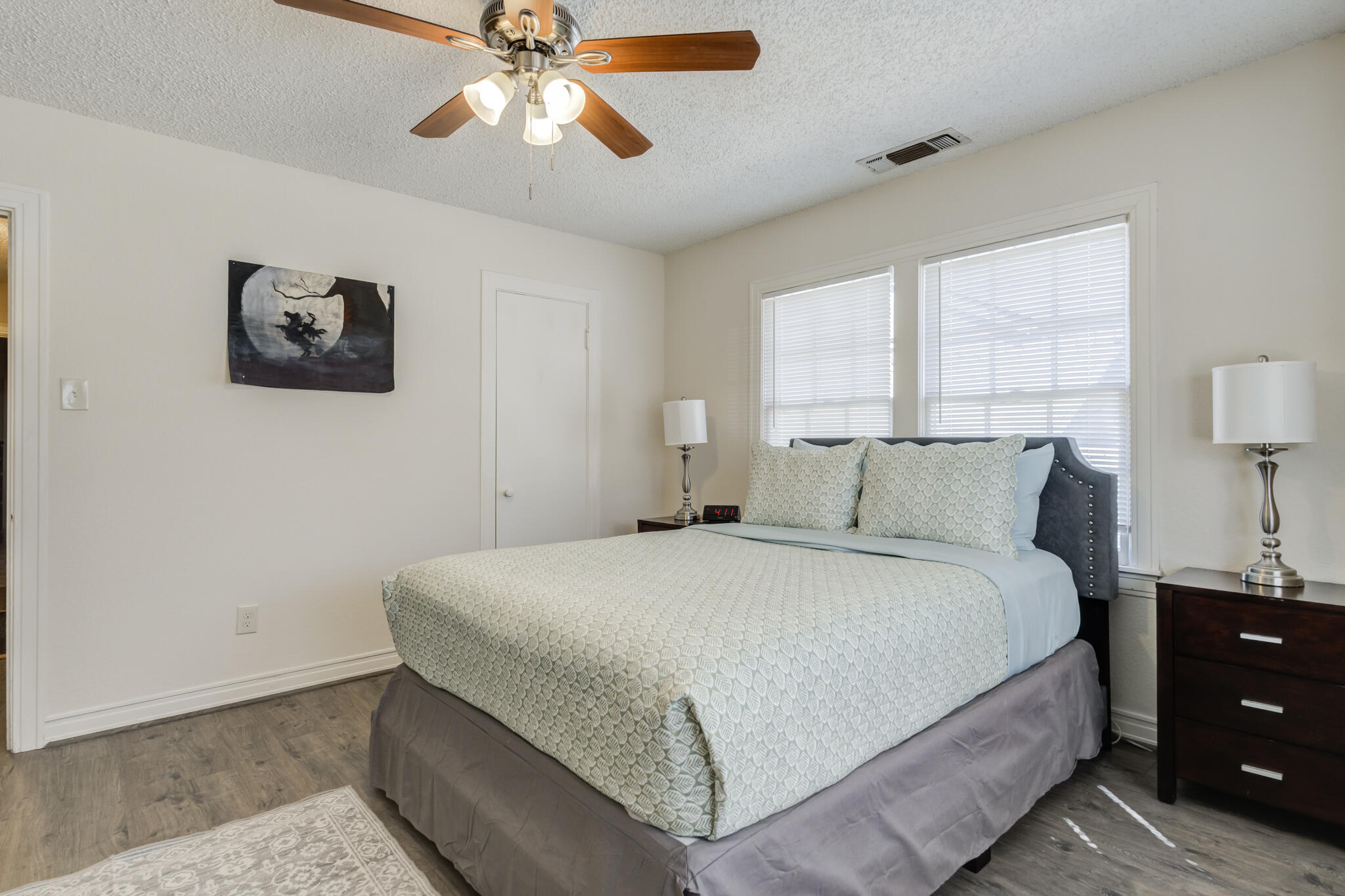 2822 23rd Street Lubbock, TX 79410 - Photo 35 of 39 a bedroom with a bed and a lamp on dresser