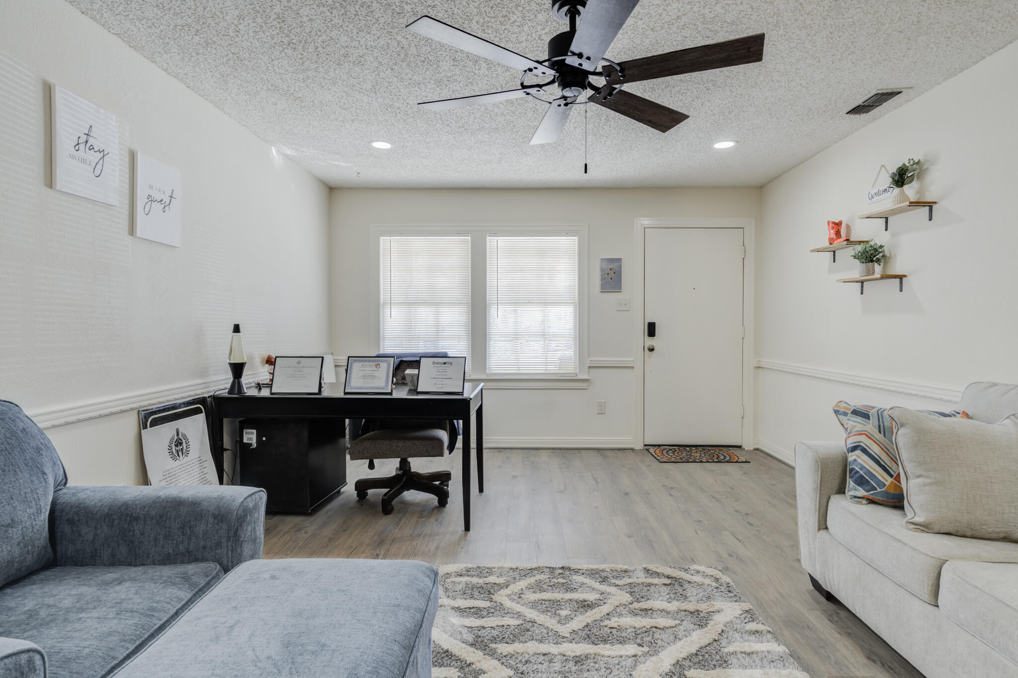 2822 23rd Street Lubbock, TX 79410 - Photo 6 of 39 a living room with furniture a window and a chandelier