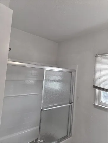 a bathroom with a glass shower door