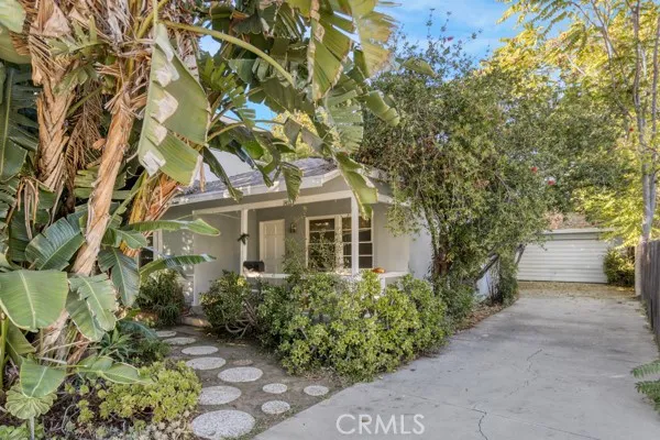 a front view of a house with a yard and fountain