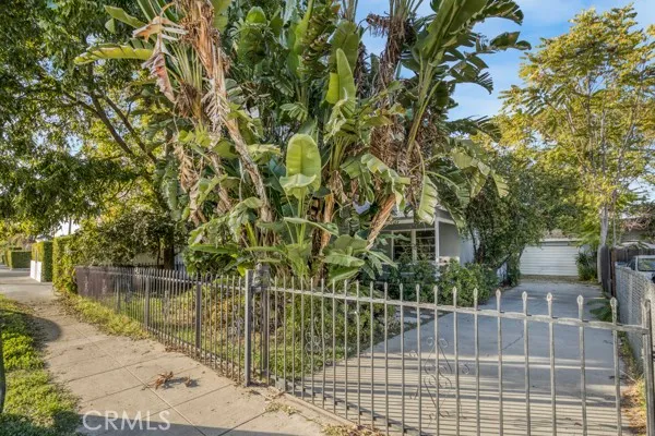 a house is sitting in middle of the forest