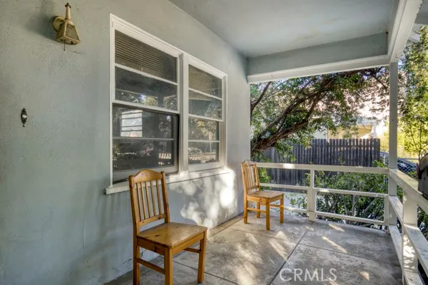 a view of chair and table in patio with wooden fence