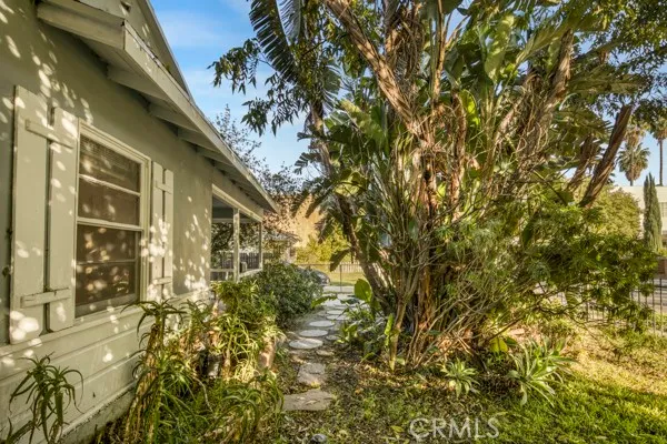an aerial view of residential houses with outdoor space and trees