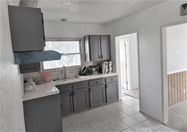 a kitchen with a sink and cabinets