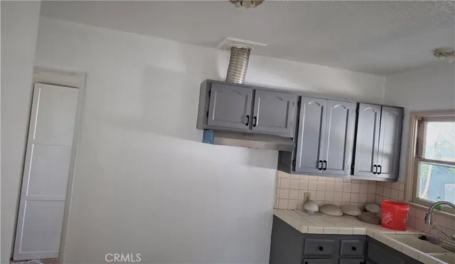 a kitchen with cabinets and window