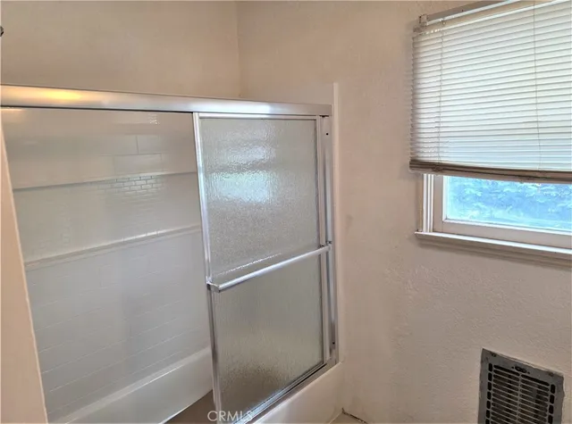 a bathroom with a glass shower door